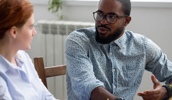 Man with Schizoafftective disorder talks to woman at table