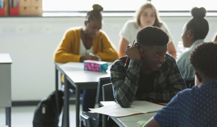 Teenager in school working with friend