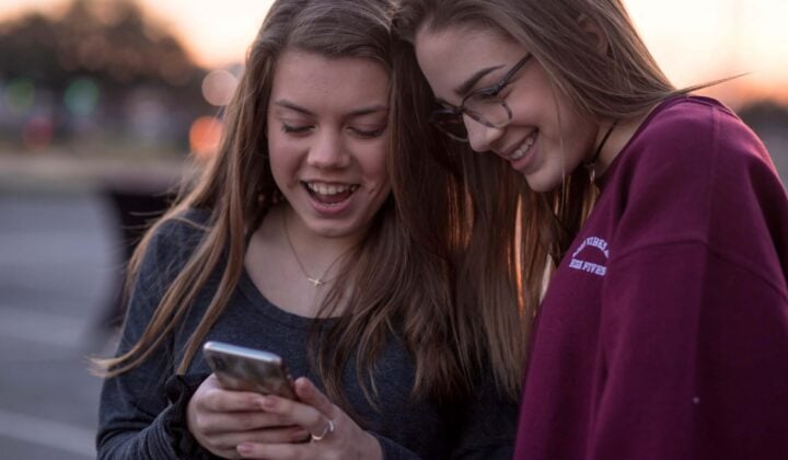 Teenagers looking at mobile