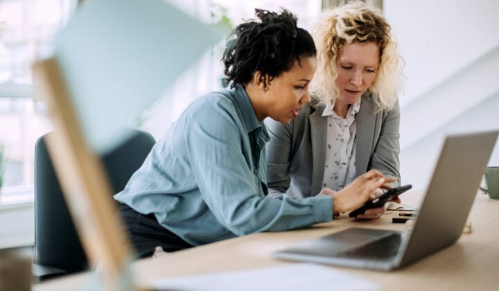 Two teacher businesswoman working together in office