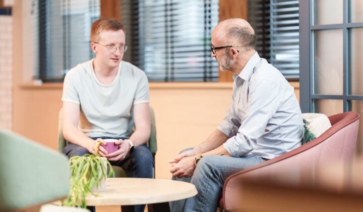 Two people chatting at work