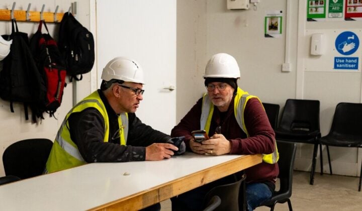 Two construction workers talking