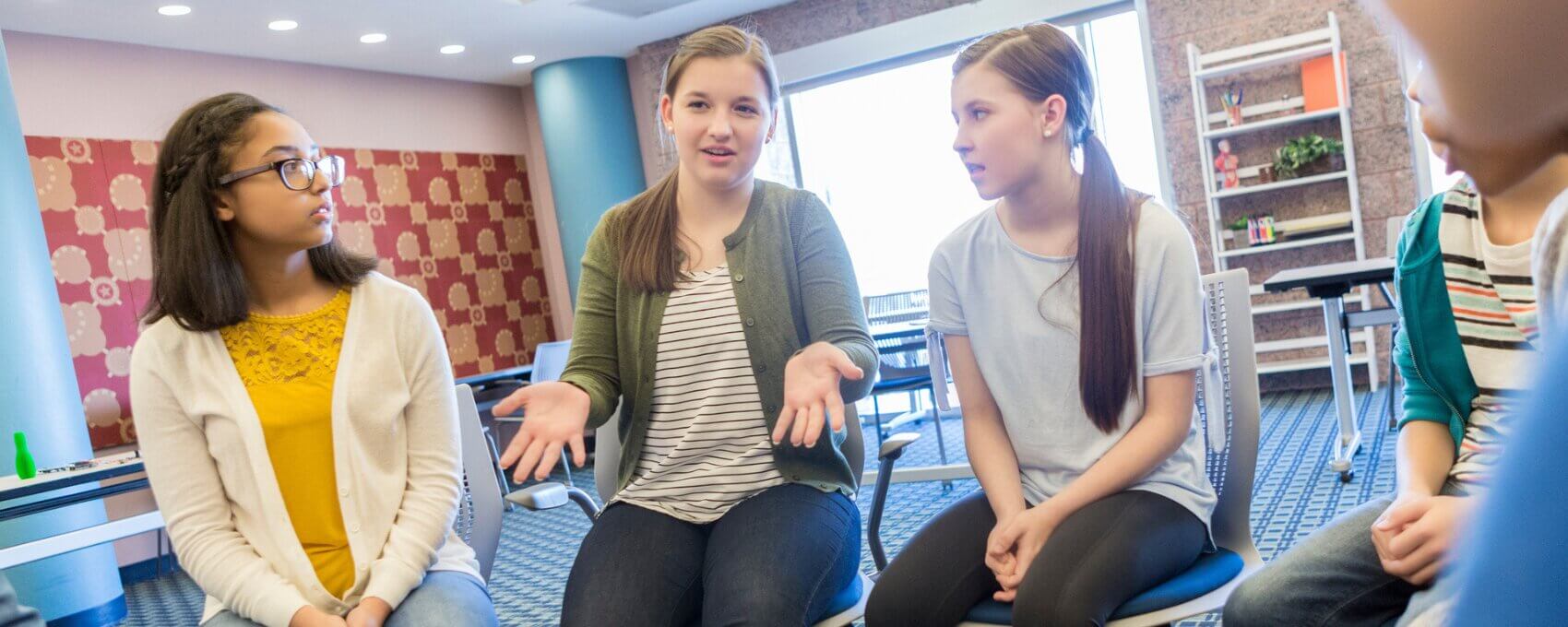 Group of young people talking in community space