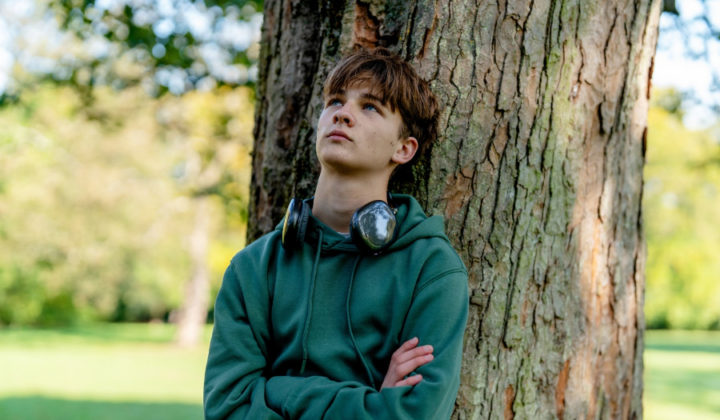 Teenager thinking and looking up at the sky